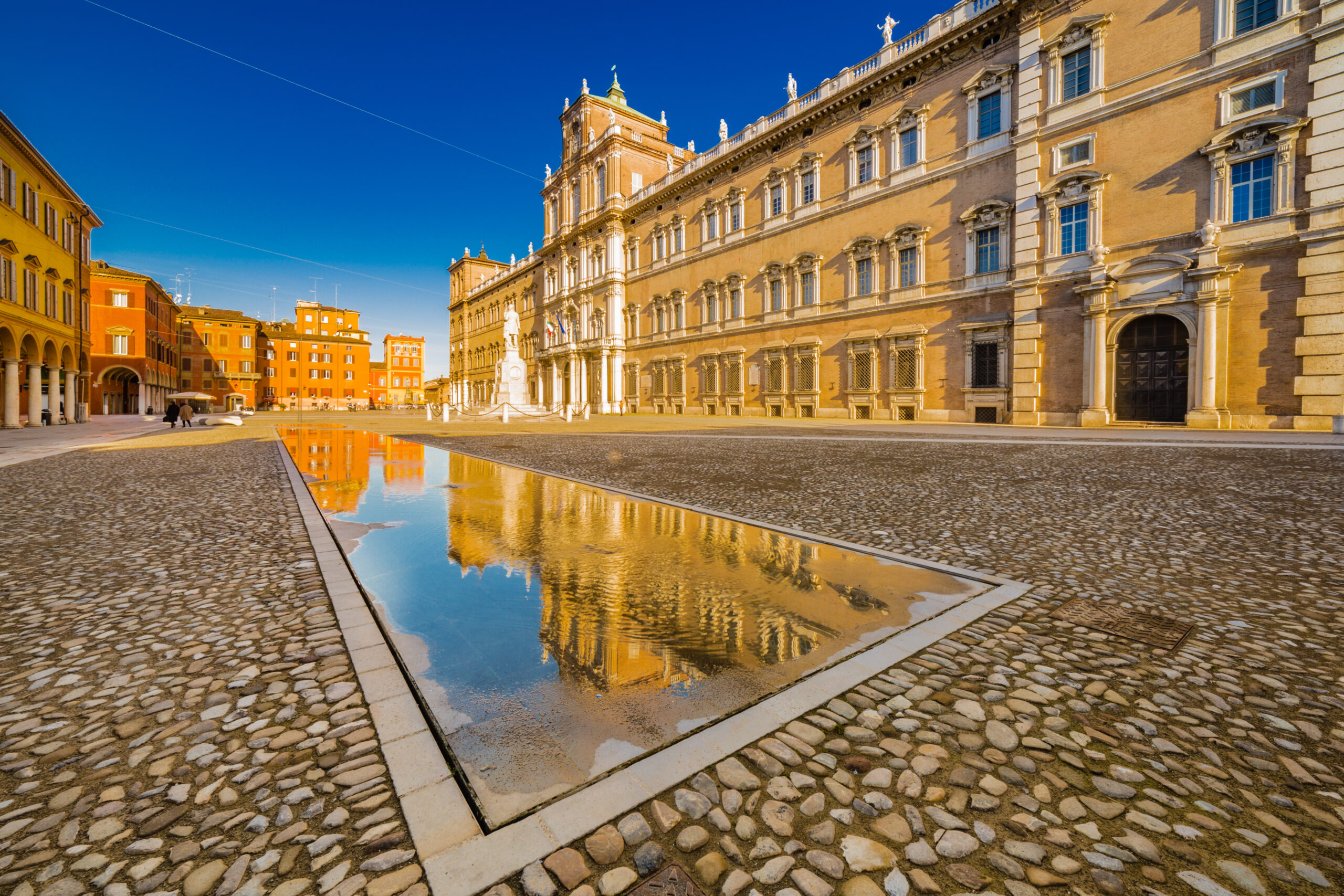 mirror of water of fountains in front of baroque Royal Palace in Modena, Italy